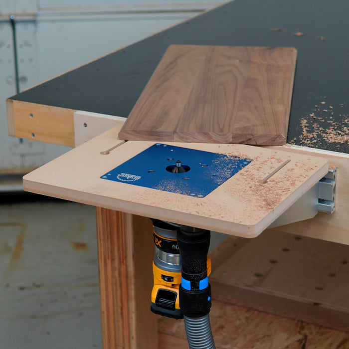 Woodworking router table with a router attached on a workshop background