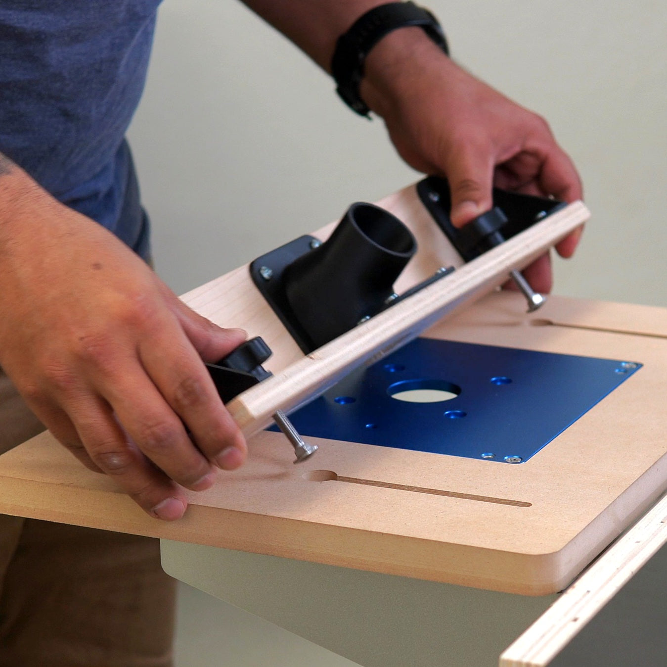Person assembling the QuickFence to a router table