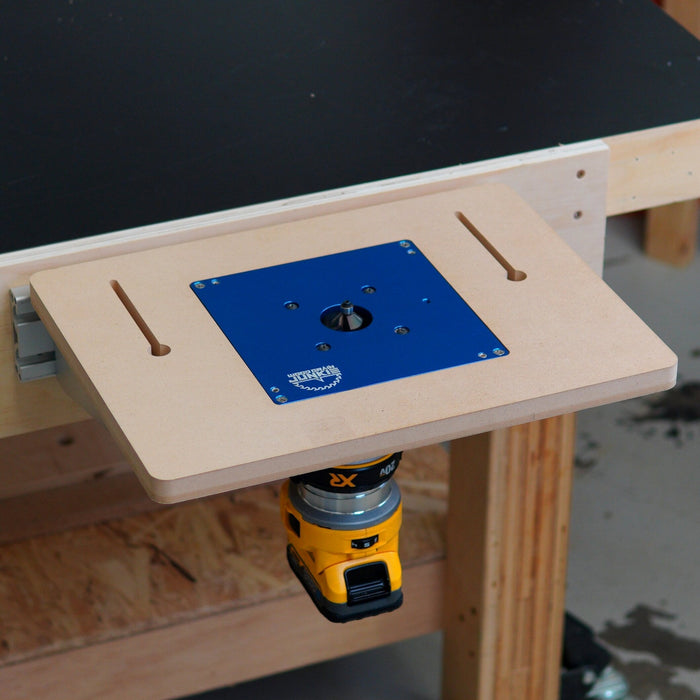 Router table with a blue insert plate on a wooden workbench