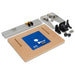 Router table kit with a blue insert plate, metal tracks, and accessories on a white background